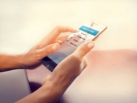 Concept online payment mobile technology and financial technology (fintech). Hand of male using mobile banking application on smartphone. Touch button with online transaction application.の写真素材