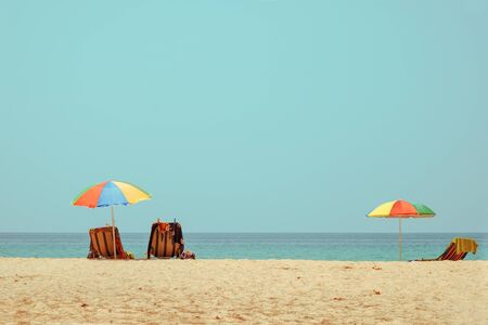 Beach chair on tropical beach with calm sky. sea view and sand beach, summer vacation background. retro color tone effect.の写真素材