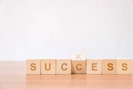 Concept of successful in business. flip changing letter on wood block from suck to success concept for improvement to successfully.の写真素材