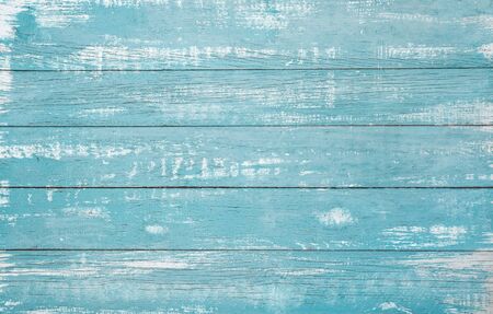 Vintage beach wood background - Old weathered wooden plank painted in turquoise or blue sea color.の写真素材