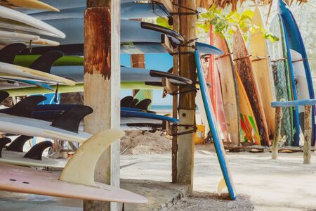 Colorful surf boards in shop for rent on the beach. water sports  equipment. vintage color tone effect. の写真素材