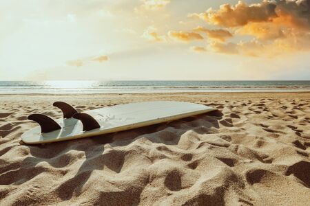 Surfboard on beach background at sunset. Travel adventure and water sport.  retro color tone effect.の写真素材