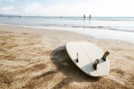 Surfboard on beach background and people. Travel adventure and water sport. relaxation and summer vacation concept.の写真素材