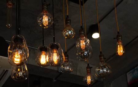 House interior of loft and rustic style. Beautiful vintage luxury light bulb hanging decor glowing...