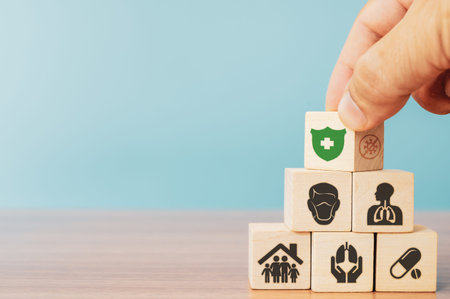Insurance and investment concept of health, life. Hand picked wooden block with insurance sign and...
