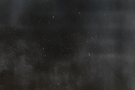 Abstract dirty or aging film. Dust particle and grain texture or dirt use for overlay film frame effect with space for vintage grunge design.の写真素材
