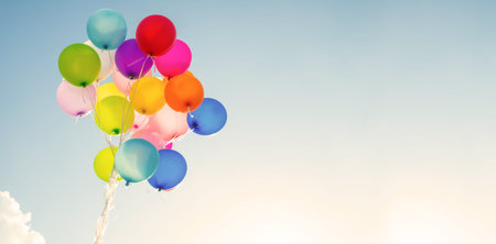 multi colored balloons done with a retro vintage  filter effect. concept of festival, celebration,...