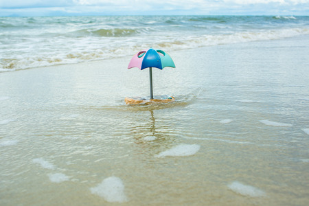Beach umbrella toy on the beach.の写真素材