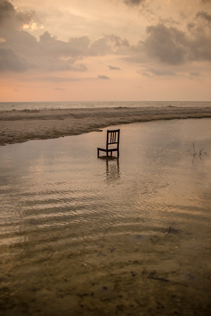 Chair in water with twilight time.の写真素材