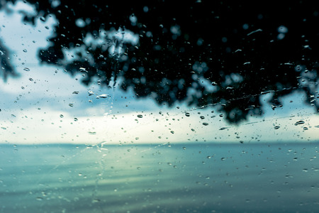 Sea view from glass with water drop and flow.の写真素材