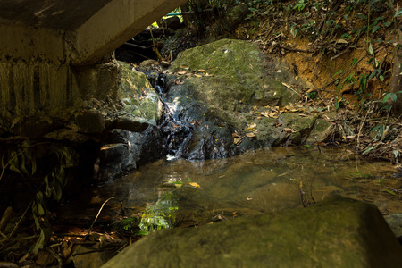 Small waterfall with natural light in deep forest.の写真素材