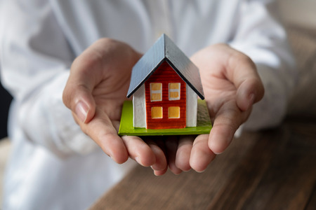 House model in hand, Concept of real estate and dealの写真素材