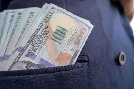 100 dollar bill sticking out from shirt pocketの写真素材