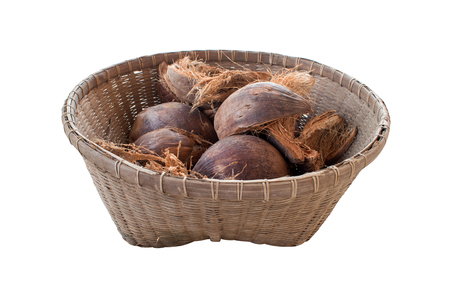 Coconut and dried coconut shell In the old wood basket. isolated on white backgroundの写真素材