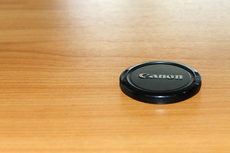 Chiang Mai, Thailand - 10 April 2018 - Canon Lens Cap on wooden background.のeditorial素材