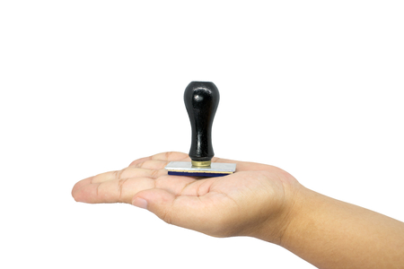 A rubber stamp with a black handle on the hand. isolated on white background.の写真素材
