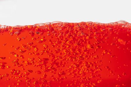red water surface waves and air bubbles isolated on white backgroundの写真素材