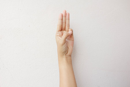 isolated hand shows the number threeの写真素材