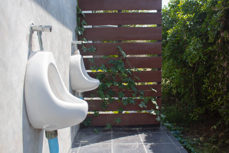 White urinal in public toilet, toilet for men and women.の写真素材