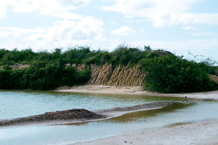 A pile of soil that has been eroded into a large rut when it rains.の写真素材