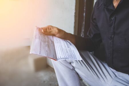 Young business people are stressed when an invoice comes to remind them to pay the debt.の写真素材