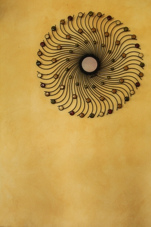 A spiral mirror on the yellow wall の写真素材