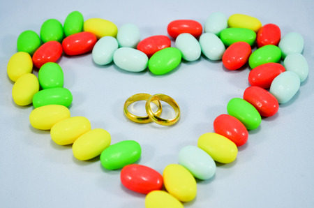 Gold Rings in candy heartの写真素材