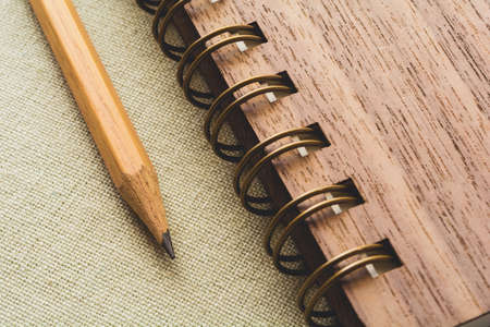 Pencil and spiral notebook on the canvas background, vintage colorの写真素材
