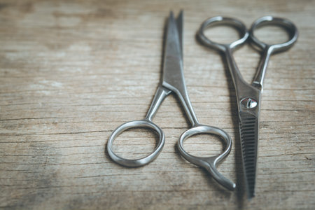 Steel scissors on wooden background in vintage style