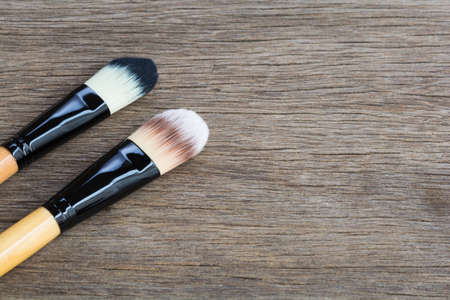 Brushes for makeup on the wooden backgroundの写真素材