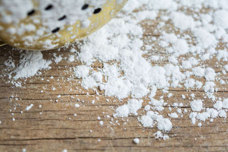 Closeup white talcum powder on wooden backgroundの写真素材
