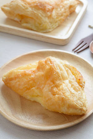 Beautiful pineapple pie in wooden plateの写真素材