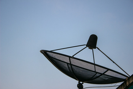 Satellite dish transmission data on background blue skyの写真素材