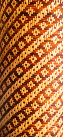 Bamboo mat texture background. Woven bamboo skin strips in traditional multipurpose usages. The woven basketry pattern provides interesting backdrop or background.の写真素材