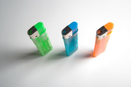 Top view of 3 colored lighters, standing.の写真素材
