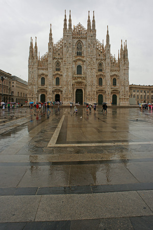 The church cathedral of Milan, Duomo of Milan and Piazza del Duomo in rainy weatherの写真素材