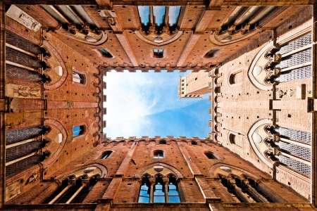 Wide angle view of famous Torre del Mangia at Palazzo Pubblico in Siena, Tuscany, Italyの写真素材