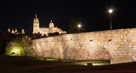 Beautiful view of the historic city of Salamanca with New Cathedral and Roman bridge, at night, Castilla y Leon region, Spainの写真素材