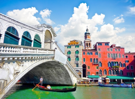 Famous Ponte di Rialto with traditional Gondola under the bridge in Venice, Italyの写真素材