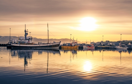 Ships lying in the harbor of Husavik at sunset, Icelandのeditorial素材