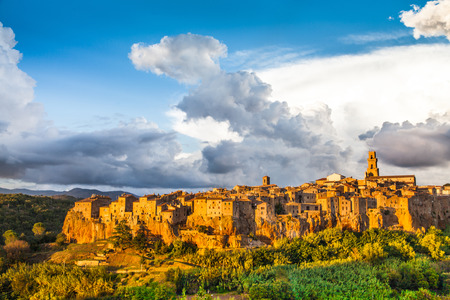 Medieval town of Pitigliano with dramatic cloudscape at sunset, Tuscany, Italyの写真素材