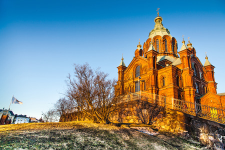 Beautiful view of famous Eastern Orthodox Uspenski Cathedral  Uspenskin katedraali  on a hill in the golden evening light on Katajanokka peninsula, Helsinki, Finlandの写真素材