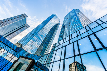 Modern skyscrapers in business district with blue skyの写真素材