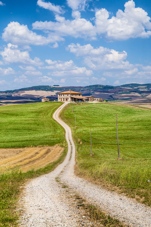 Scenic Tuscany landscape with traditional farm house and rolling hills in Val d Orcia, Tuscany, Italyの写真素材