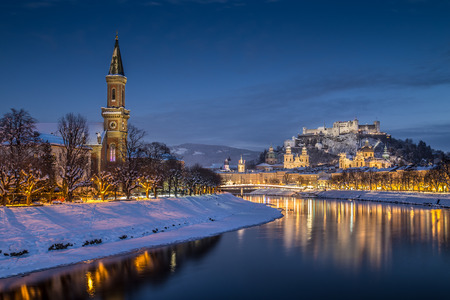 Beautiful view of the historic city of Salzburg with Salzach river in winter during blue hour, Salzburger Land, Austriaの写真素材