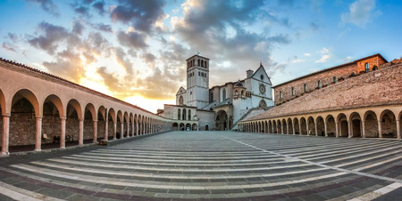 Famous Basilica of St. Francis of Assisi Basilica Papale di San Francesco with Lower Plaza at sunset in Assisi, Umbria, Italyの写真素材