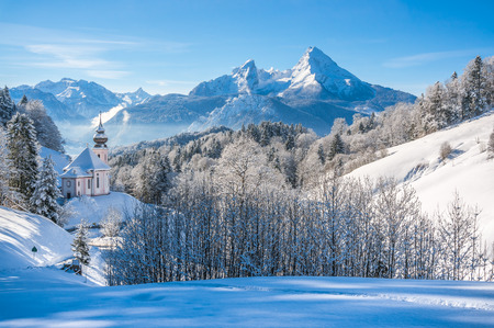 Panoramic view of beautiful winter landscape in the Bavarian Alps with pilgrimage church of Maria Gern and famous Watzmann massif in the background, Nationalpark Berchtesgadener Land, Bavaria, Germanyの写真素材