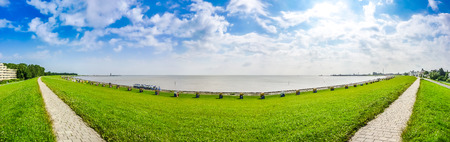 Panoramic view of beautiful long beach with typical north sea beach chairs in Cuxhaven on a sunny summer day, Lower Saxony, Germanyの写真素材
