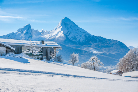 Beautiful mountain landscape in the Bavarian Alps with traditional farm house and  famous Watzmann in the background, Nationalpark Berchtesgadener Land, Bavaria, Germanyの写真素材