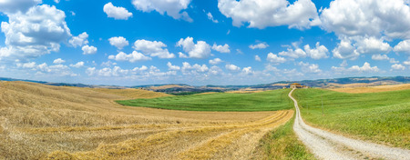 Scenic Tuscany landscape with rolling hills and traditional farm house in Val d'Orcia, Italyの写真素材